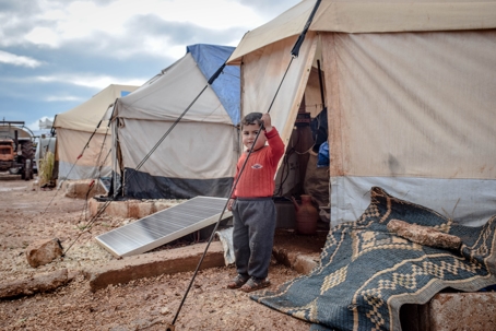 Child standing in front of tent