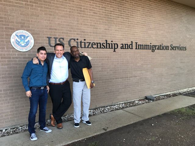 Photo with client in front of USCIS