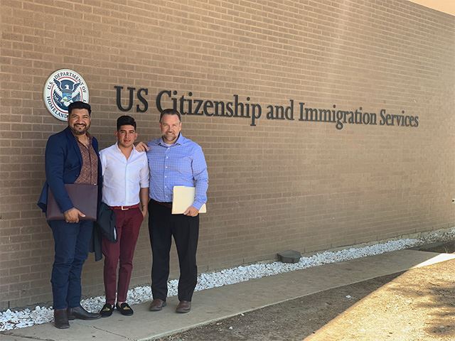 Photo with client in front of USCIS