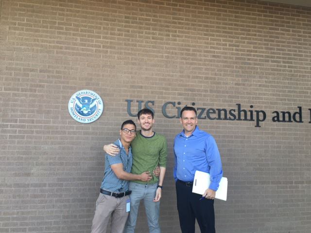 Photo with client in front of USCIS